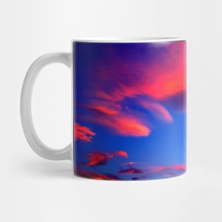 Plenty of bright pink clouds scattered on the yellow-blue sky Mug